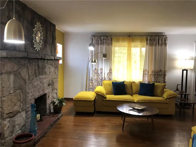 a dining room with a table chairs and a mirror