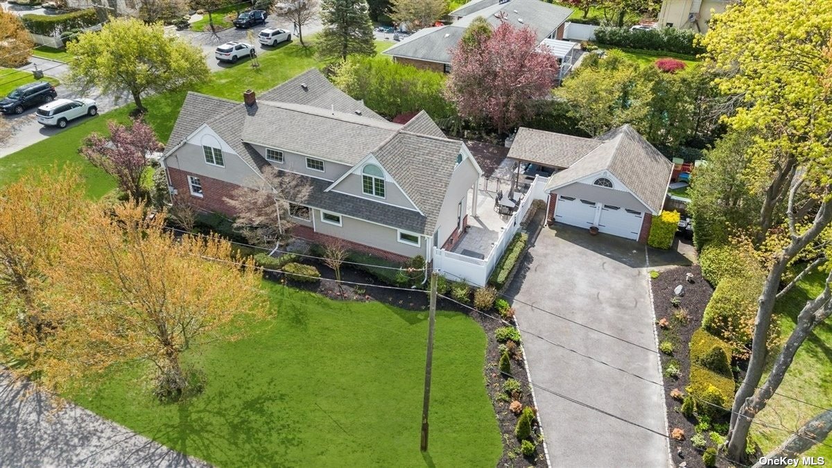 an aerial view of a house with pool garden and patio