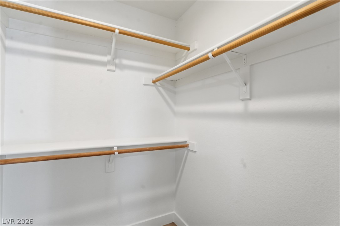 5449 Bugle Way, Unit 104 Las Vegas, NV 89108 - Photo 27 of 33 This spacious walk-in closet offers ample storage for an organized wardrobe.