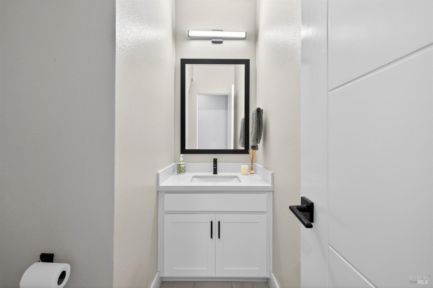 2215-2217 Versaro Drive Santa Rosa, CA 95403 - Photo 17 of 45 a bathroom with a sink and a mirror