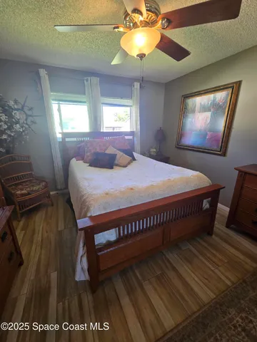 a bed sitting in a bedroom next to a window