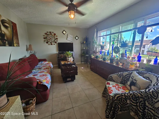 a bedroom with furniture and a flat screen tv