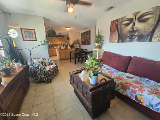 a living room with furniture and flowers