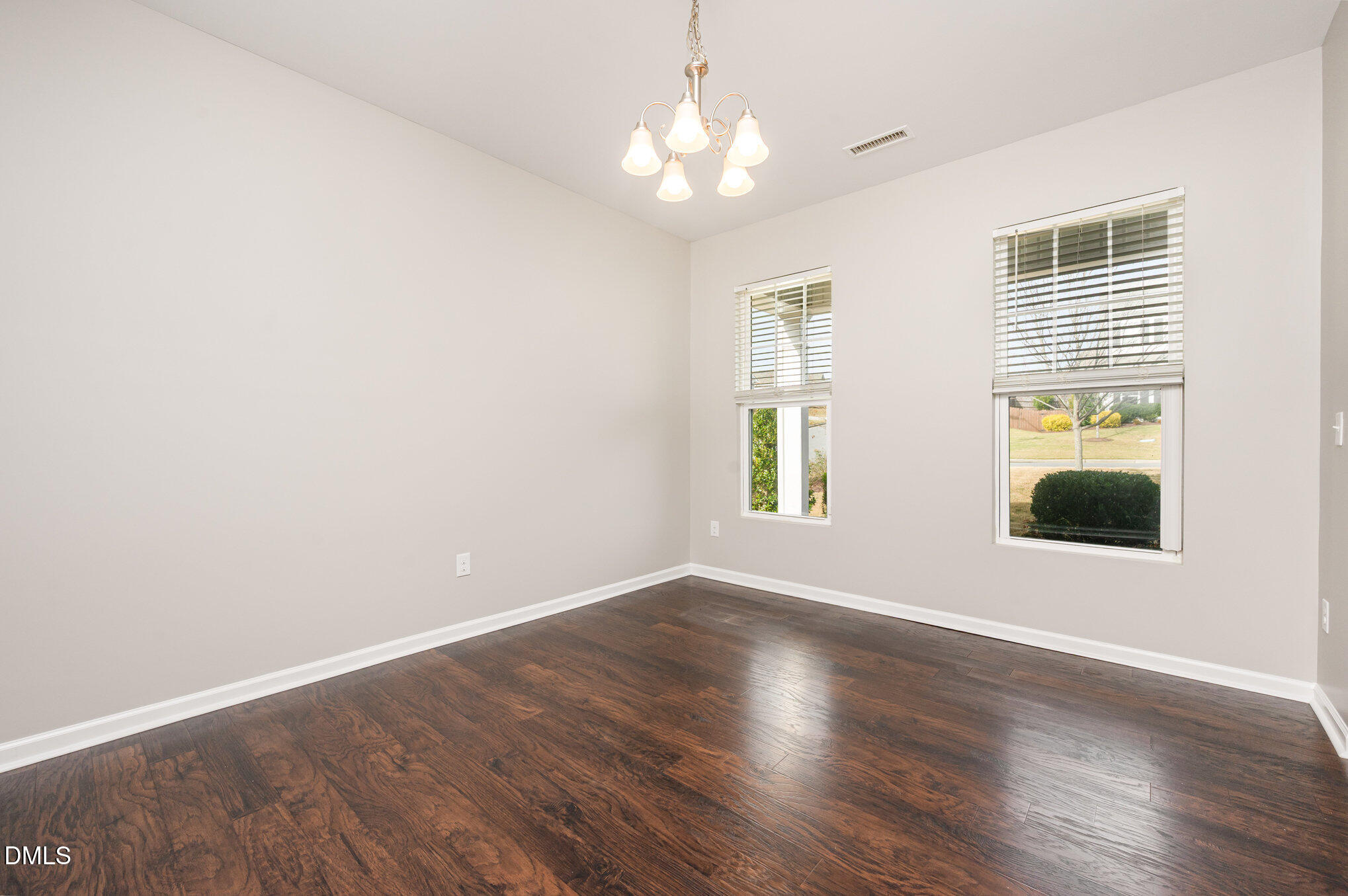 18 Dover Ridge Court Chapel Hill, NC 27517 - Photo 7 of 40 an empty room with wooden floor and windows