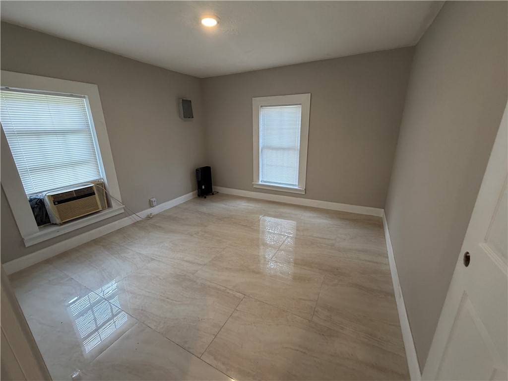 302 Sirrine Street Honea Path, SC 29654 - Photo 19 of 24 A well-lit interior space with sleek, light-colored tile flooring and natural illumination from multiple windows.