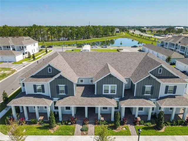 a aerial view of a house with swimming pool garden and outdoor seating