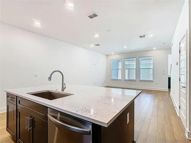 a bathroom with a granite countertop toilet sink and mirror