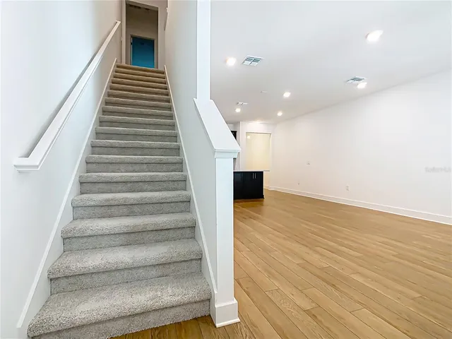 an empty room with an entryway and window