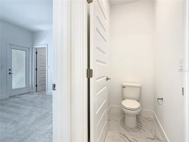 an aerial view of residential houses with outdoor space and river view