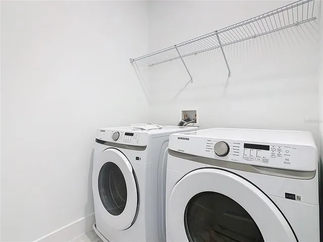 an aerial view of a house with garden space and a street view