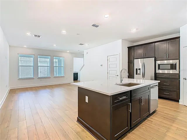 a kitchen with stainless steel appliances a refrigerator and a stove