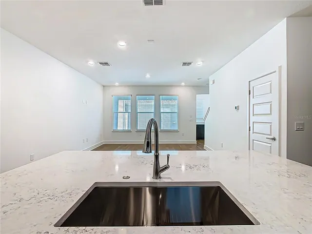 an empty room with closet and windows