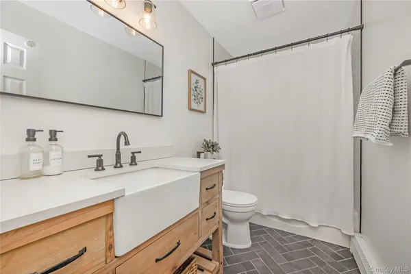 a bathroom with a sink toilet and shower
