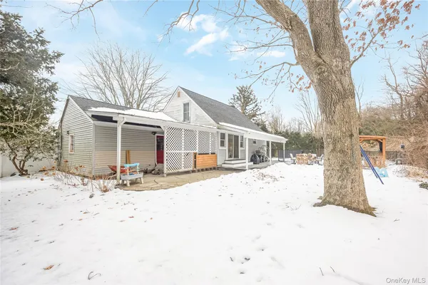 a front view of a house with a yard covered in snow