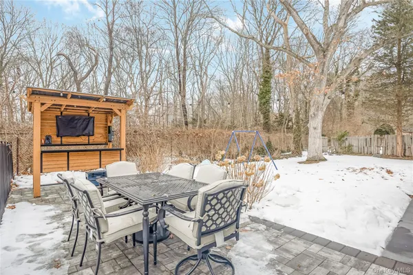 a view of a backyard with a table and chairs