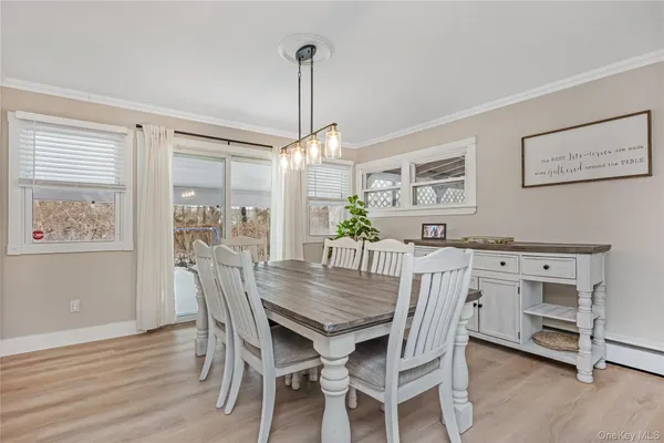 a view of a dining room with furniture window and wooden floor