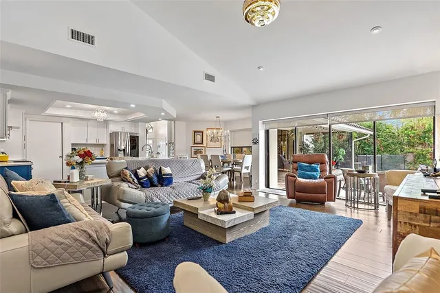 a living room with furniture floor to ceiling window and couch
