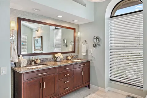 a large kitchen with stainless steel appliances granite countertop a stove and a wooden floors