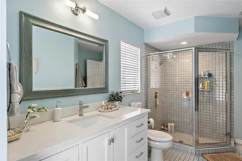 a bedroom with a bed painting on wall and a window