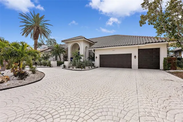 a view of a house with a yard and a garage
