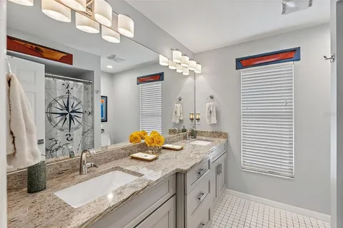 a bathroom with a sink a vanity and a shower