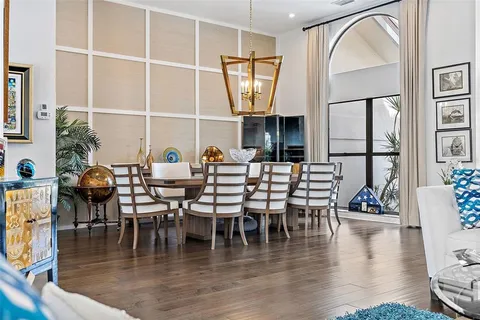 a dining room with furniture window and wooden floor