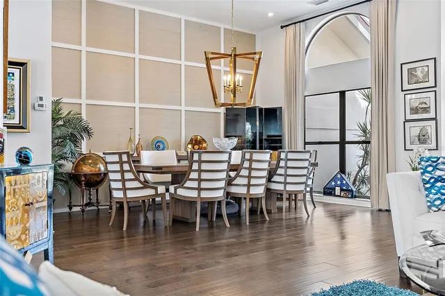 a dining room with furniture window and wooden floor