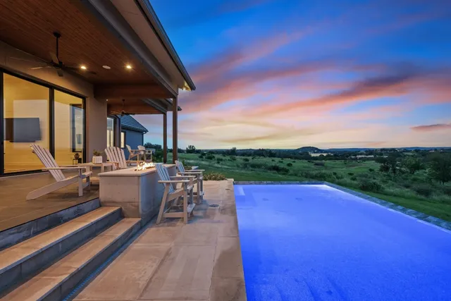 a view of a patio with dining table and chairs with a patio