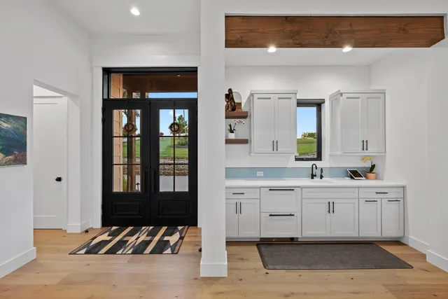 a spacious bathroom with a double vanity sink and a mirror