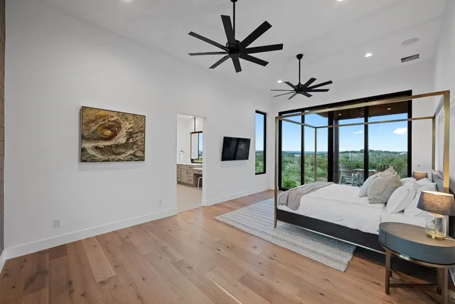 a living room with furniture large windows and a flat screen tv