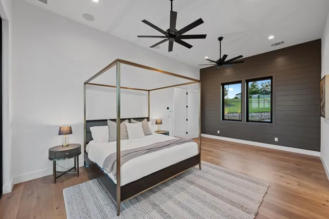 a bedroom with a bed and a ceiling fan