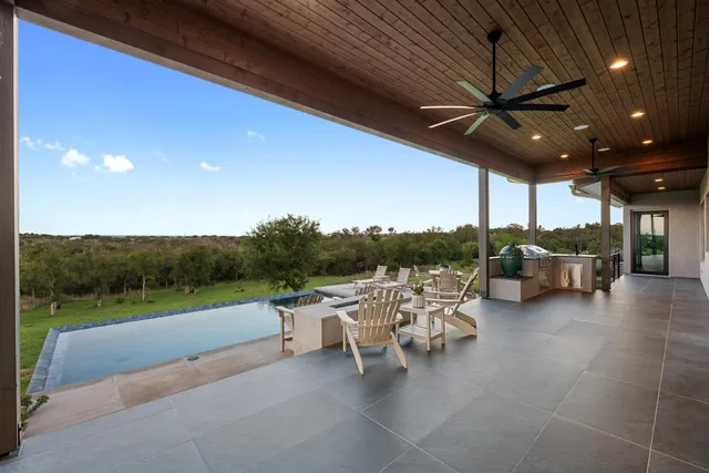 a view of a patio with a table and chairs