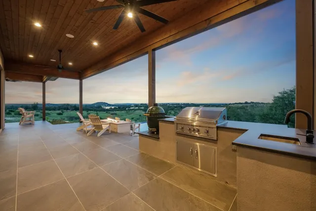a view of a terrace with furniture and garden view
