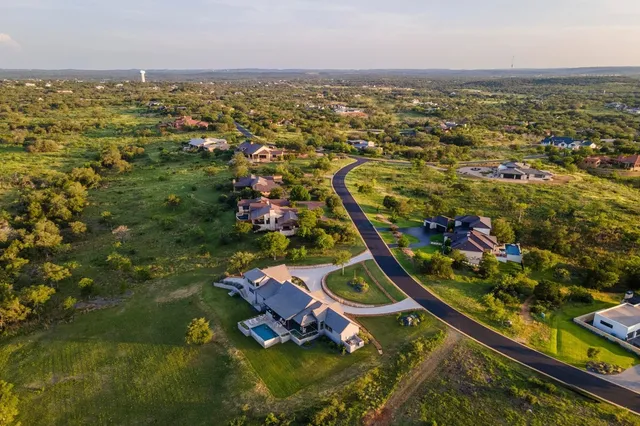 an aerial view of residential house with outdoor space and swimming pool