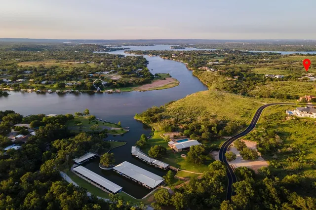 an aerial view of a house with a lake view