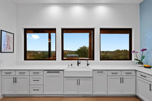 a bathroom with a sink mirror and window