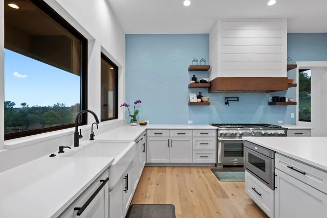 a kitchen with a sink stove and cabinets