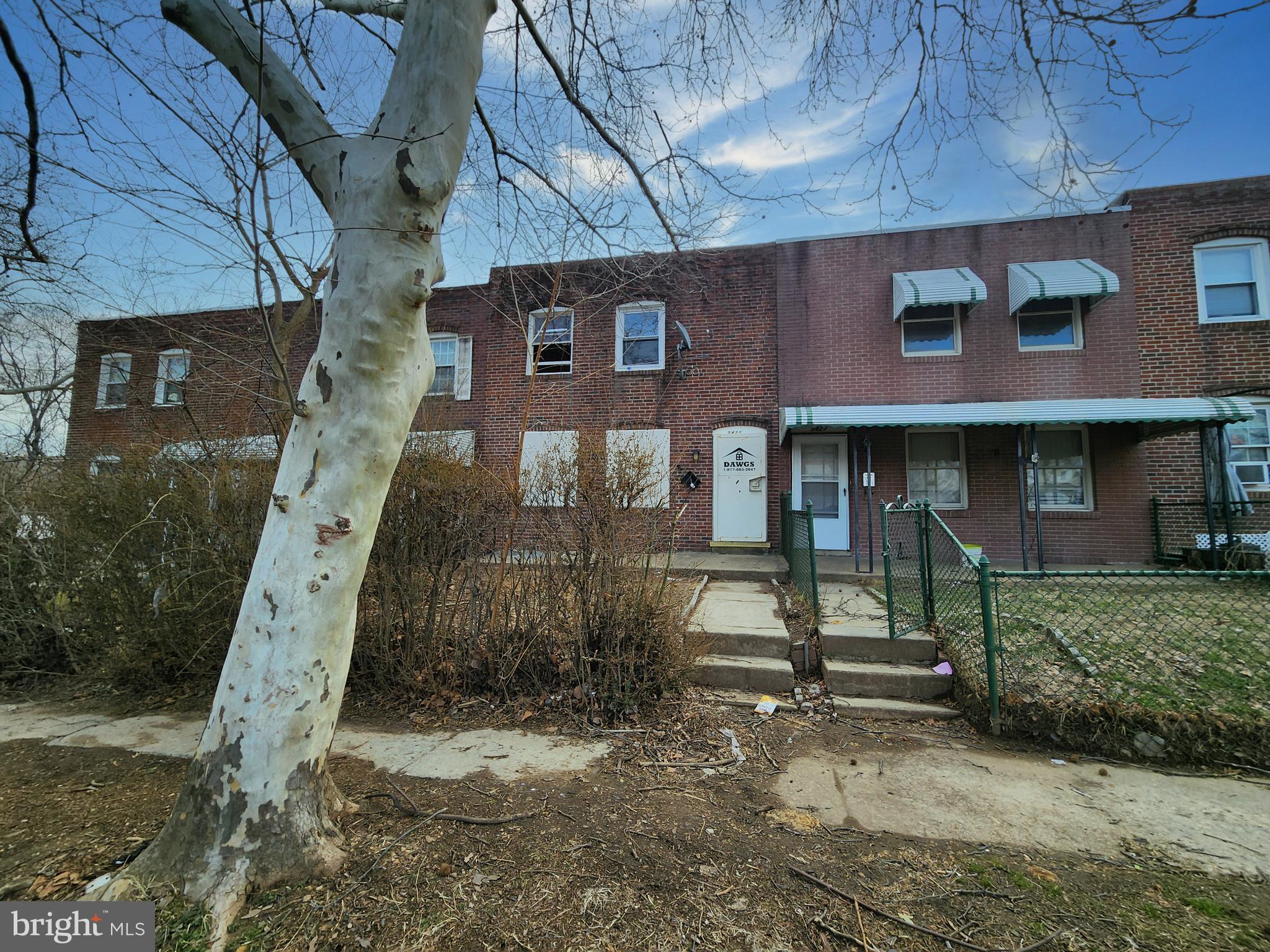 a front view of a building with a yard