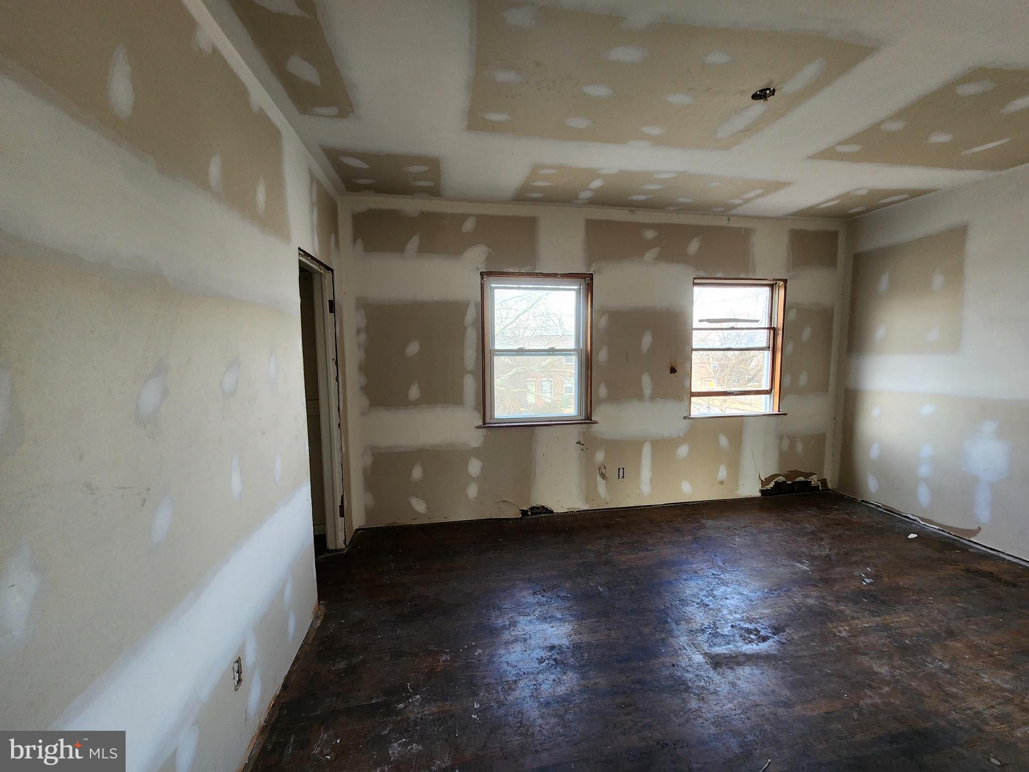 3425 6th Street Baltimore, MD 21225 - Photo 24 of 35 an empty room with wooden floor and windows