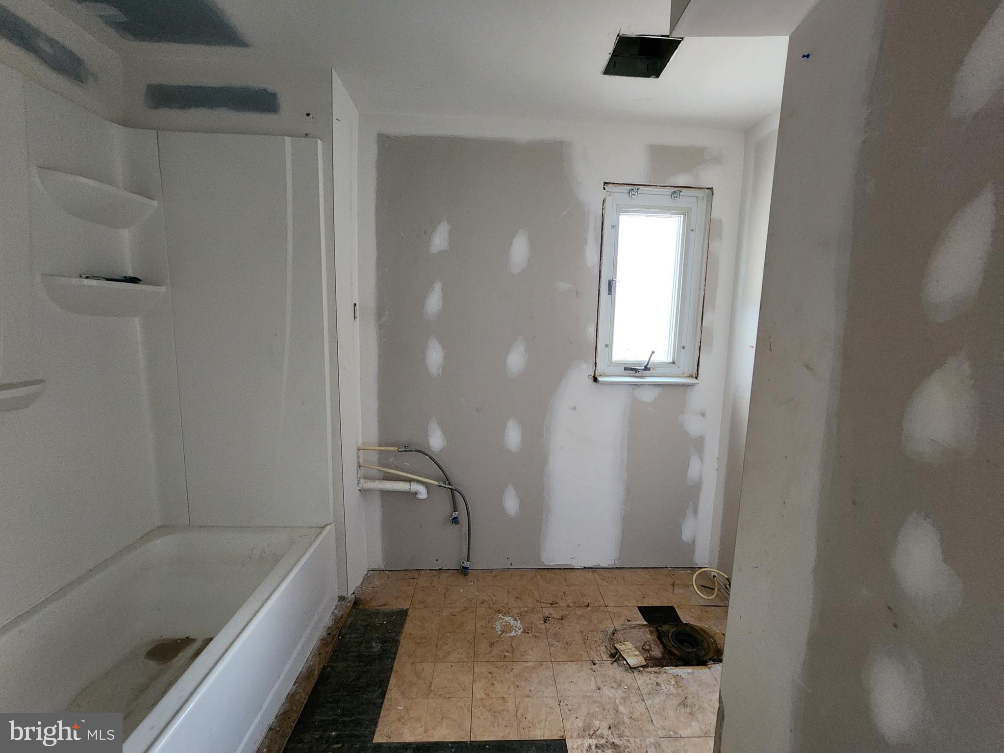 3425 6th Street Baltimore, MD 21225 - Photo 30 of 35 a bathroom with a bathtub and shower