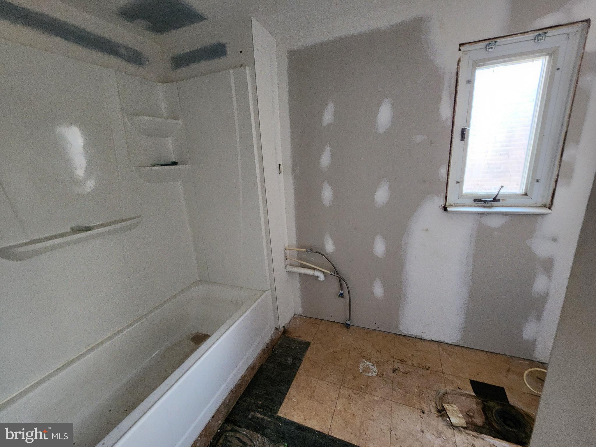 3425 6th Street Baltimore, MD 21225 - Photo 31 of 35 a bathroom with a bathtub and a shower