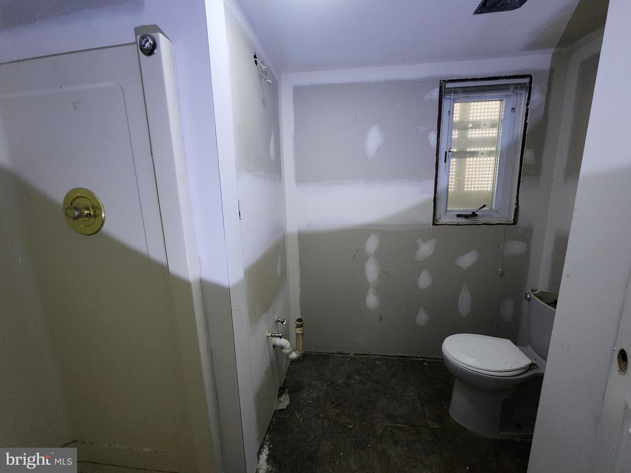 3425 6th Street Baltimore, MD 21225 - Photo 10 of 35 a bathroom with a toilet and a shower