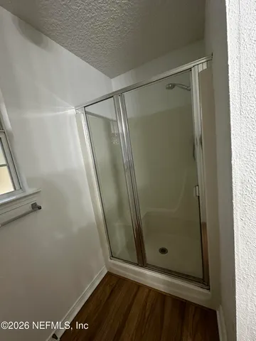 a bathroom with a glass door shower