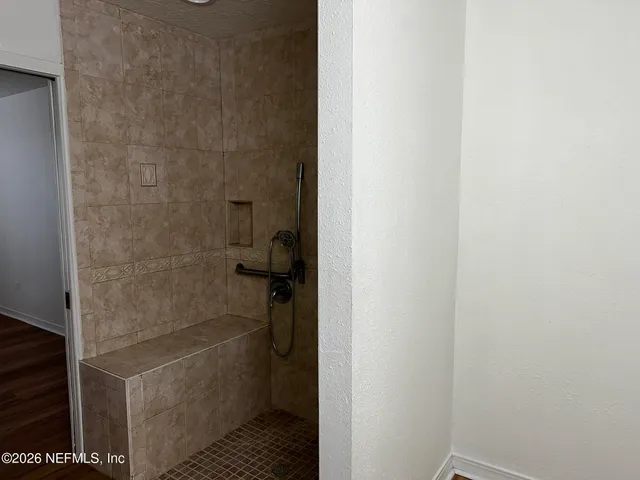 a bathroom with a granite countertop shower