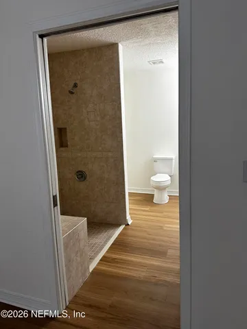 a bathroom with a shower and a toilet