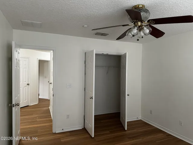 a view of a livingroom with wooden floor and white walls