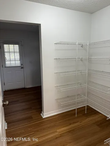 a view of walk in closet with empty racks
