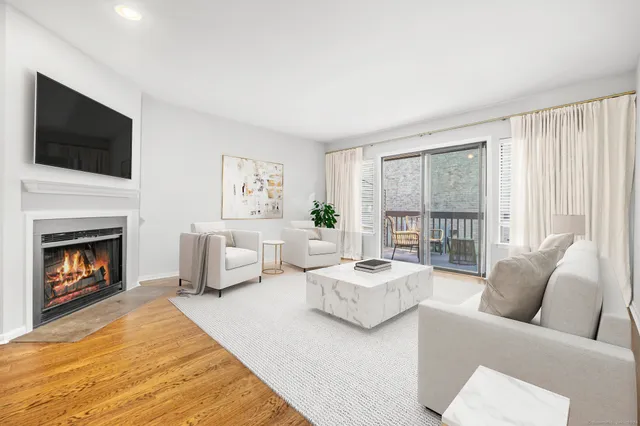 a living room with furniture fireplace and flat screen tv