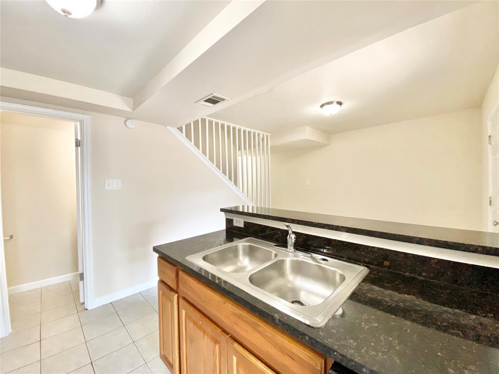 8001 C Rothington Road, Unit 21 Dallas, TX 75227 - Photo 13 of 32 a view of kitchen sink microwave and refrigerator