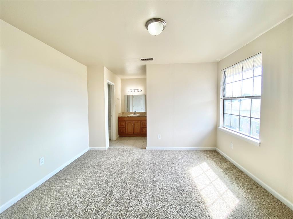 8001 C Rothington Road, Unit 21 Dallas, TX 75227 - Photo 15 of 32 an empty room with windows and cabinet